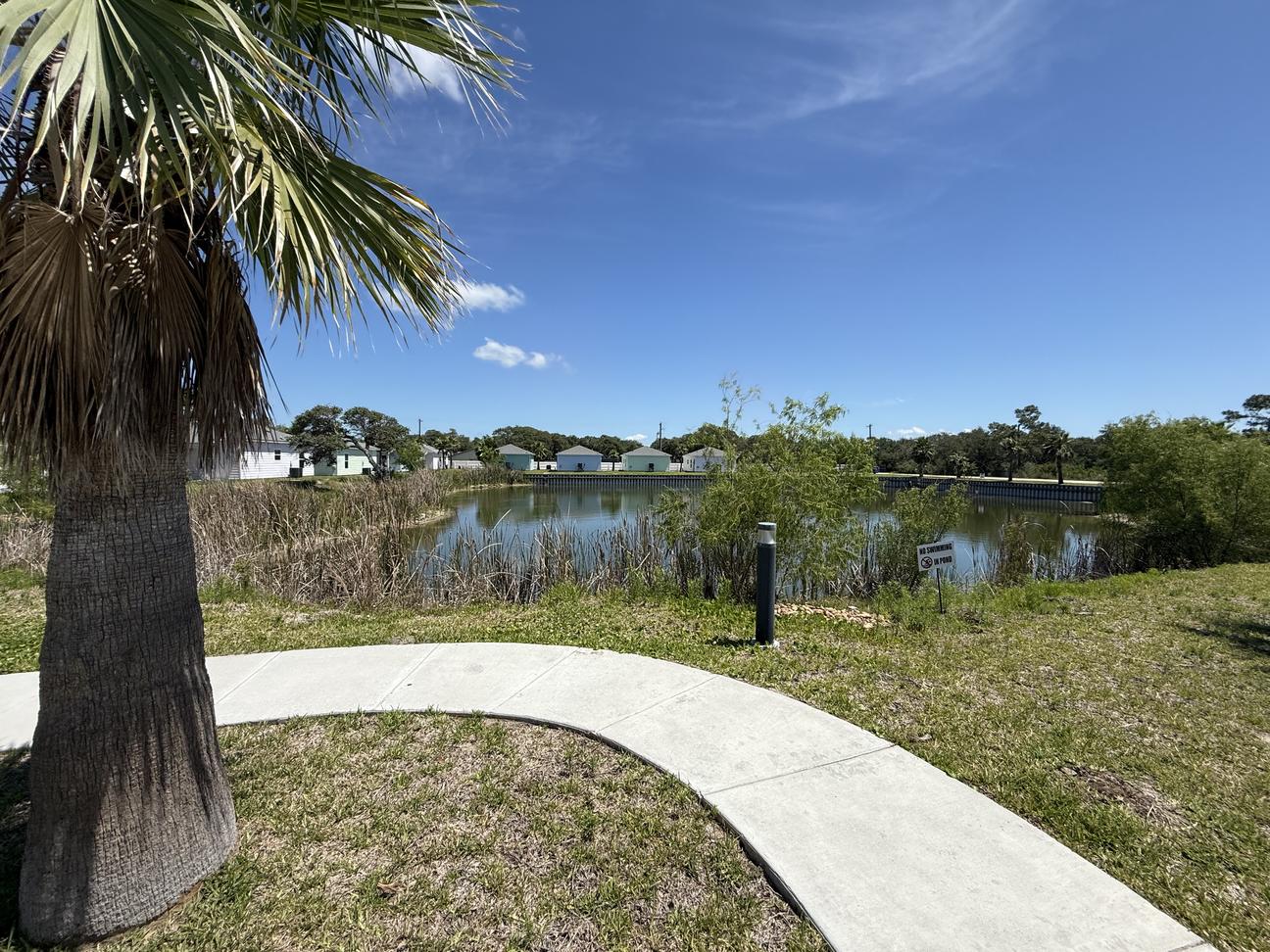 A sidewalk leads to the pond which allows catch and release fishing. 