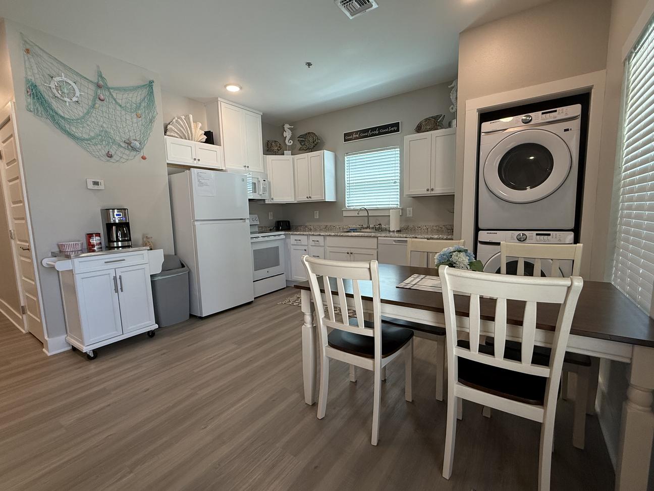 Coffee bar, full sized applicaned in a bright kitchen and stack washer and dryer. 