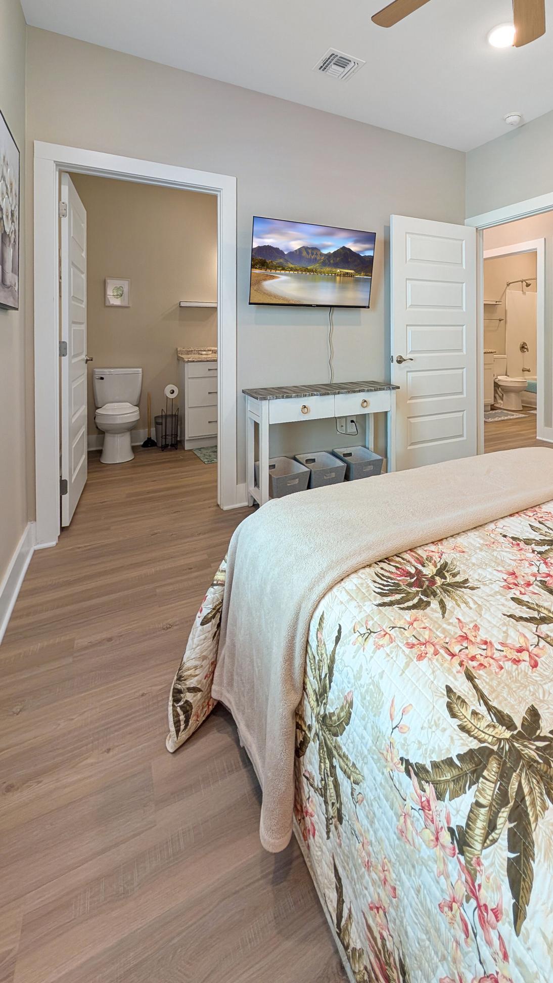Tan coastal decor in the master bedroom, queen bed and smart tv