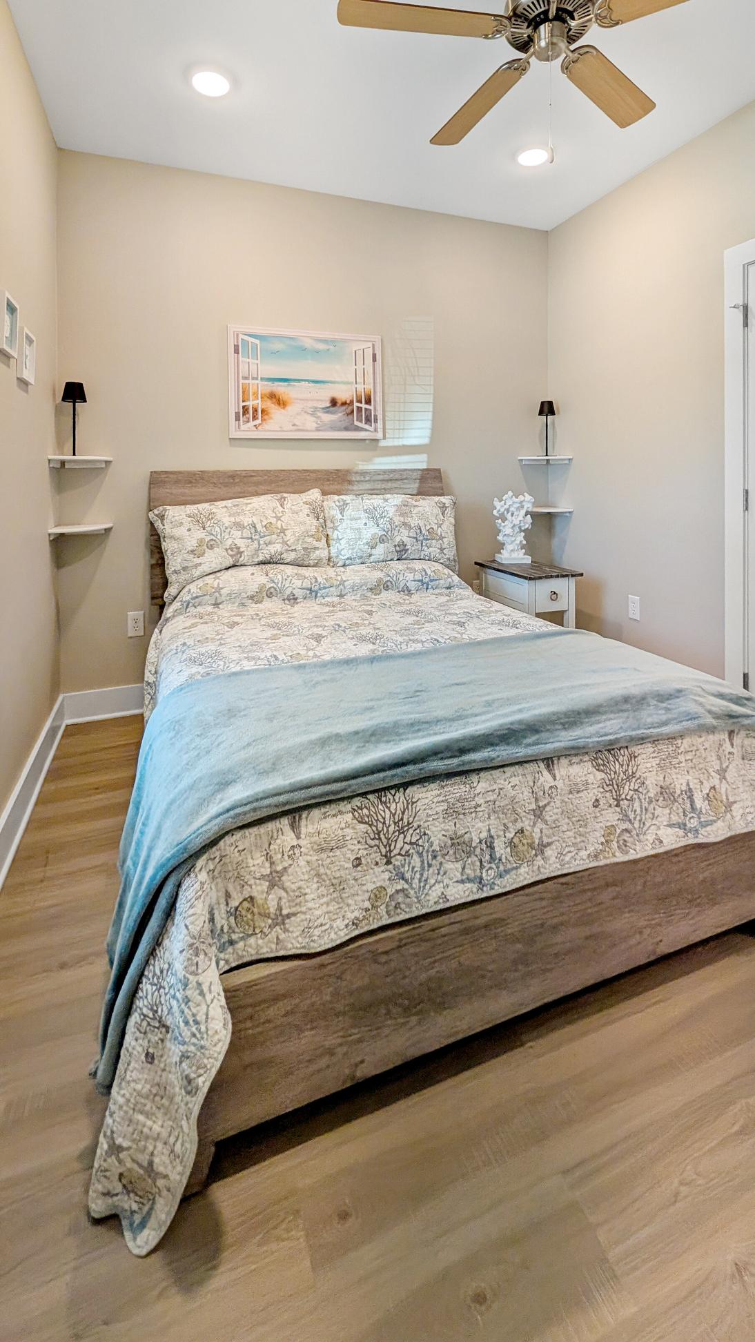 Queen bed with coastal themed bedding