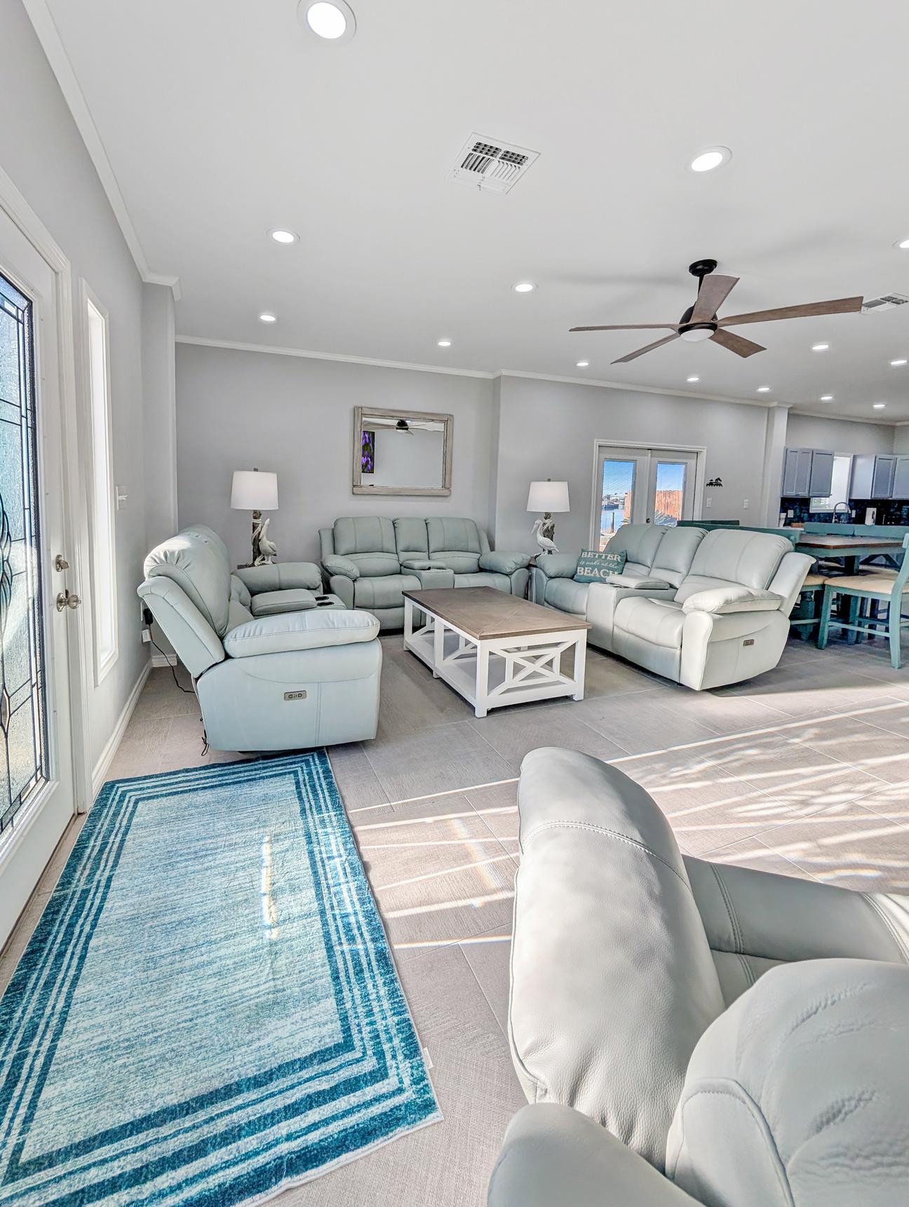 Large open living room with eight recliners in coastal decor