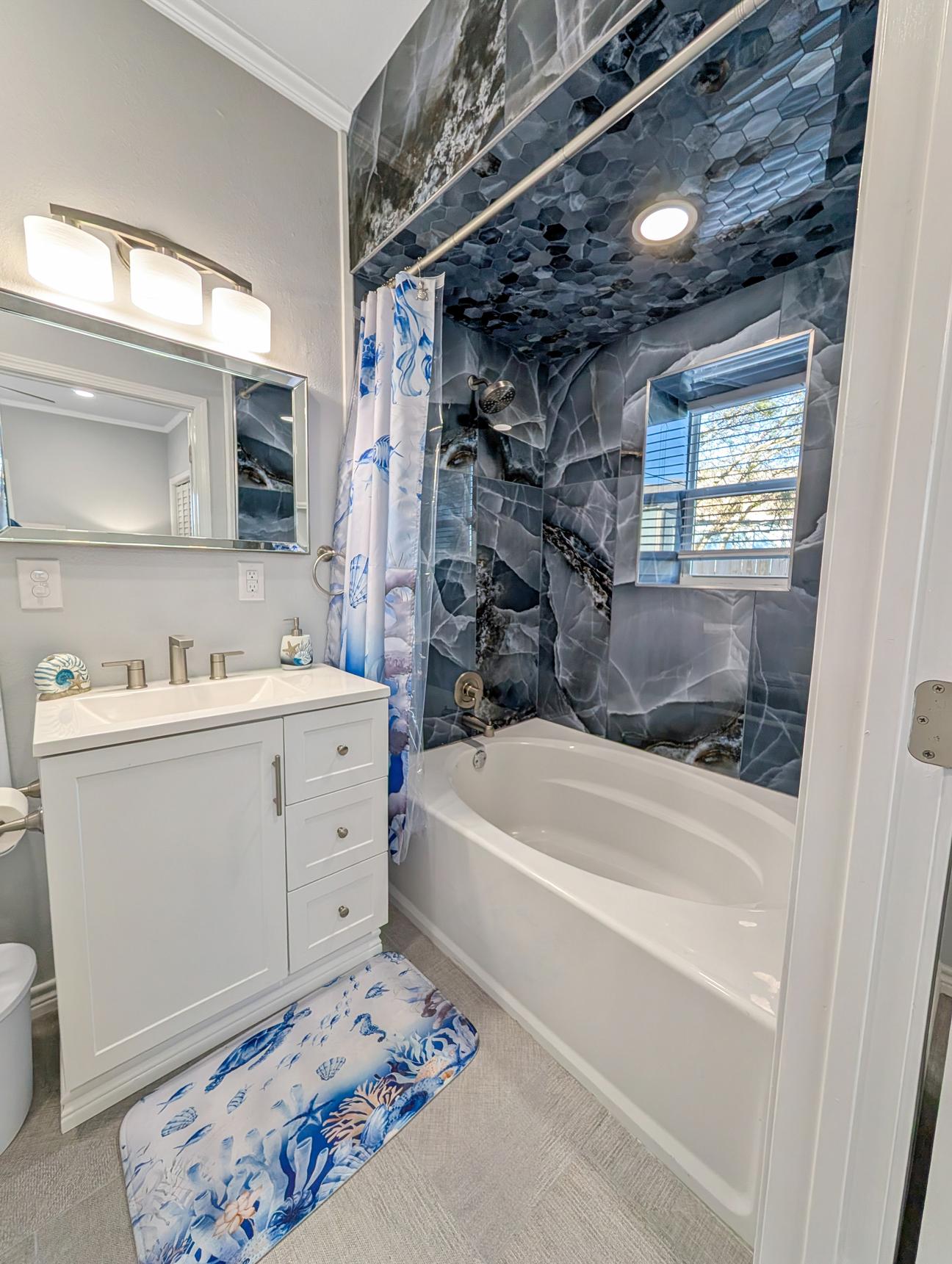 Blue tiled tub shower combo