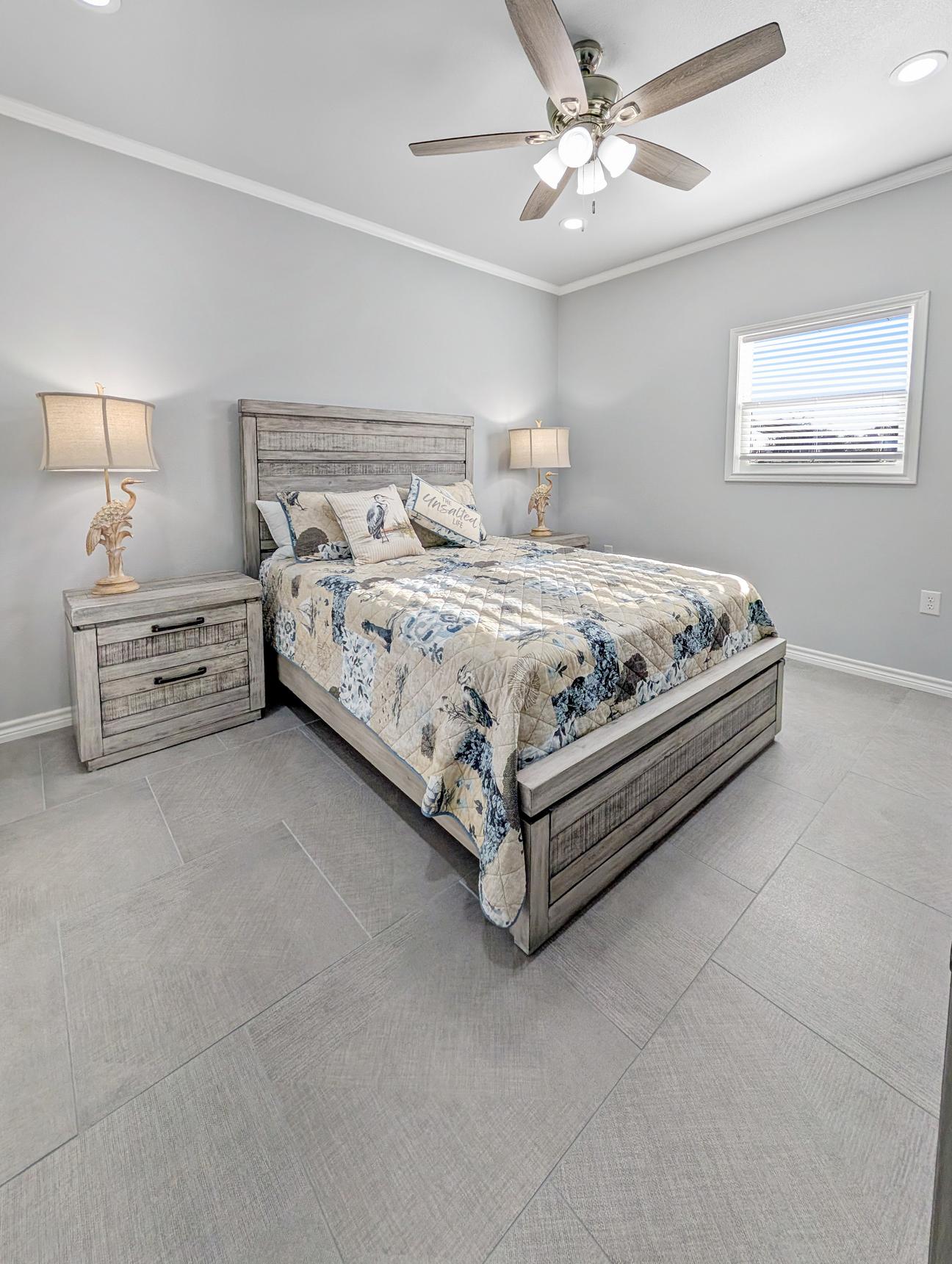 Queen bed with coastal bird-themed decor