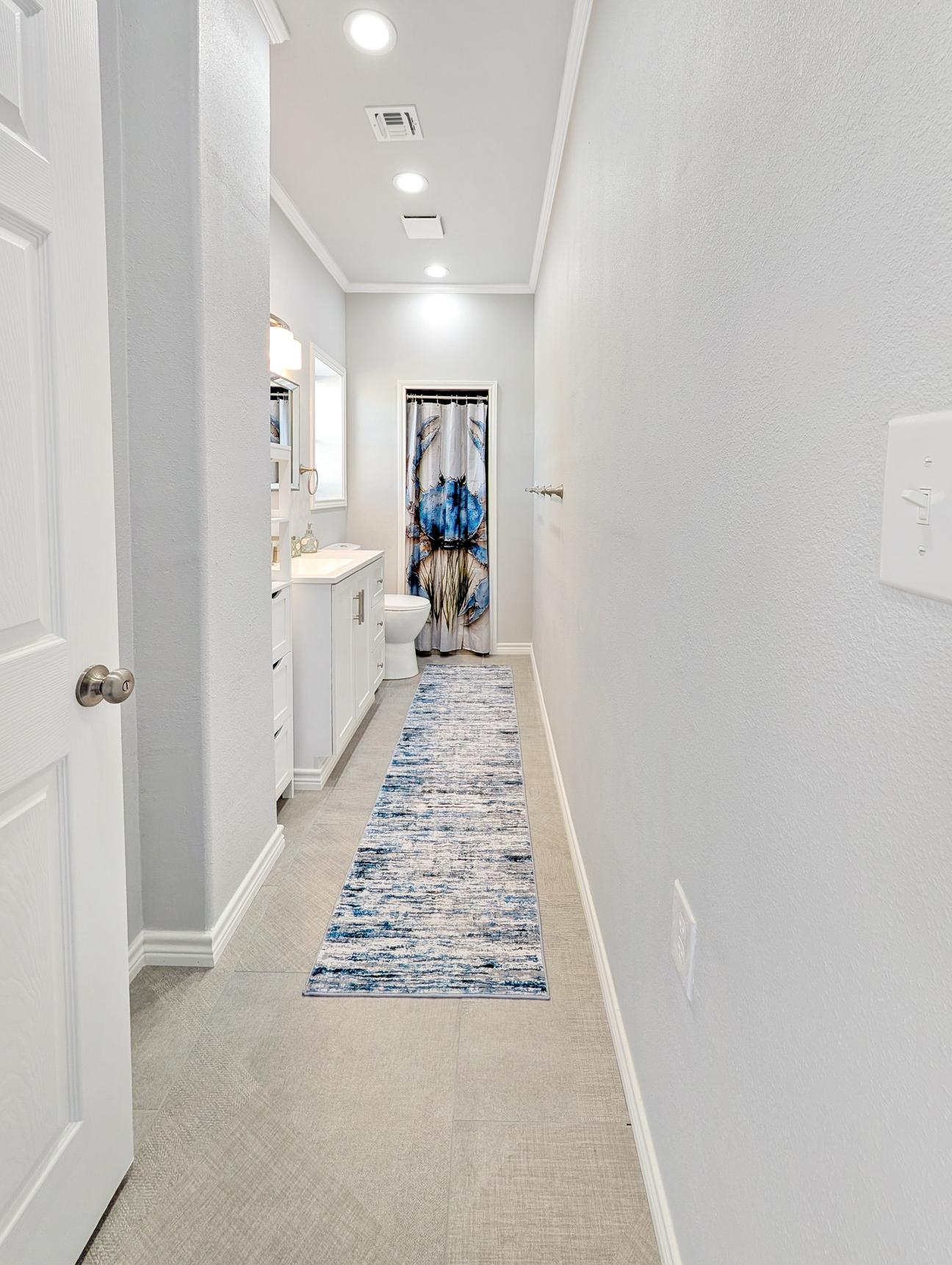 Long hallway with two bedrooms on each side