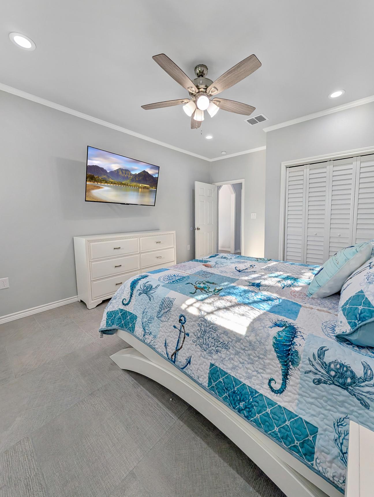Smart TV and king sized bed with sealife themed decor