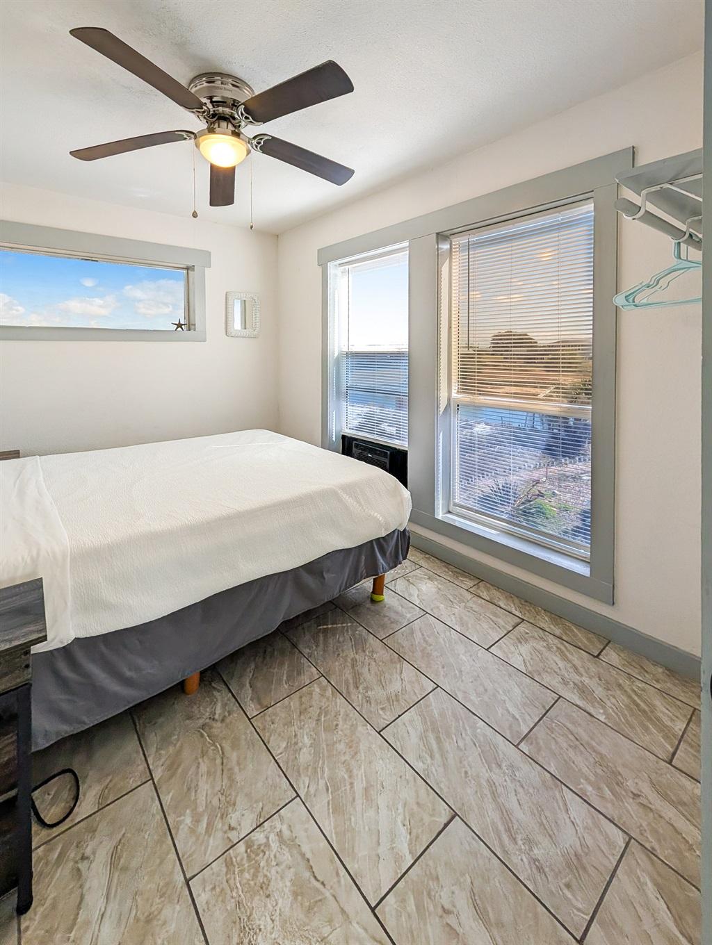 Queen bed, ceiling fan, water views out the window