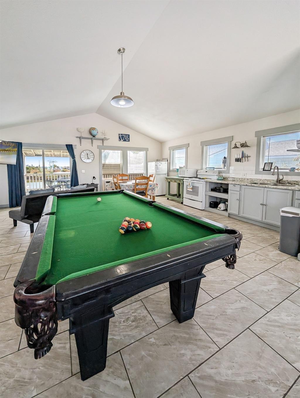 Open floor plan with pool table and couch