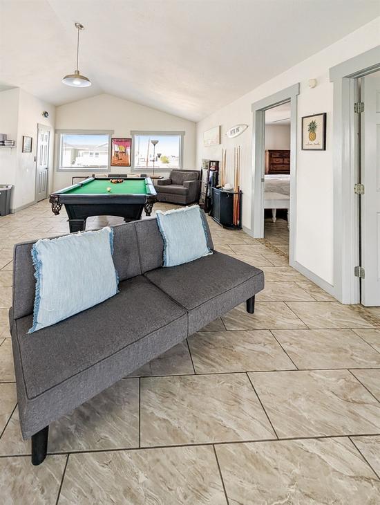 couch, pool table in the living room