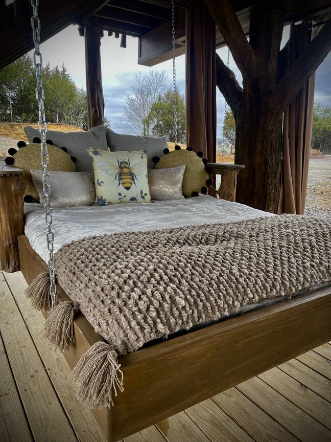 Lower porch custom made outdoor swinging day bed. 