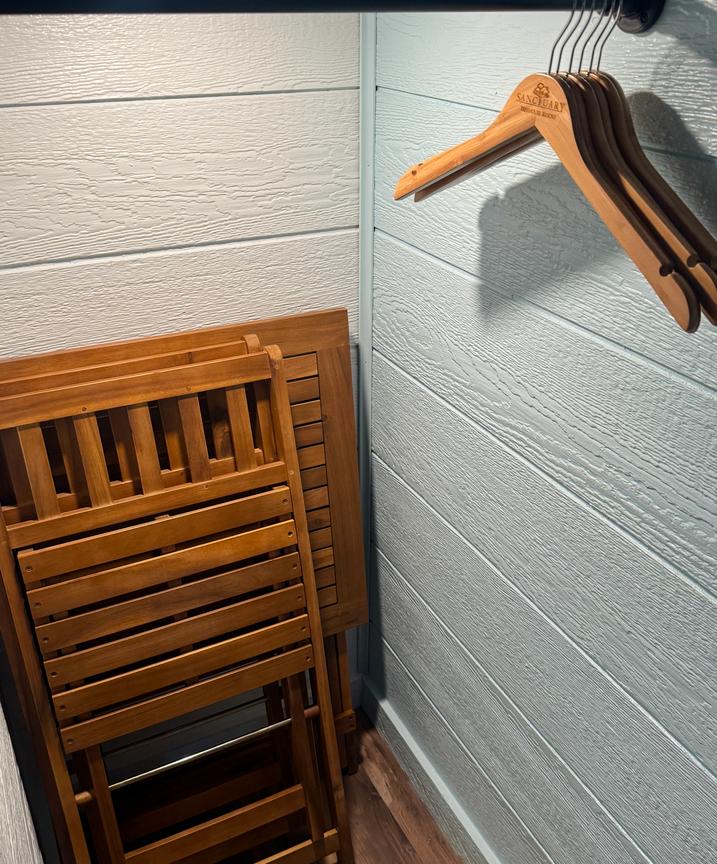 CLOSET WITH BAMBOO HANGERS - LUGGAGE RACK FOR SUIT CASES - COLLAPSIBLE TABLE TOP WITH TWO CHAIRS FOR EXTRA SEATING