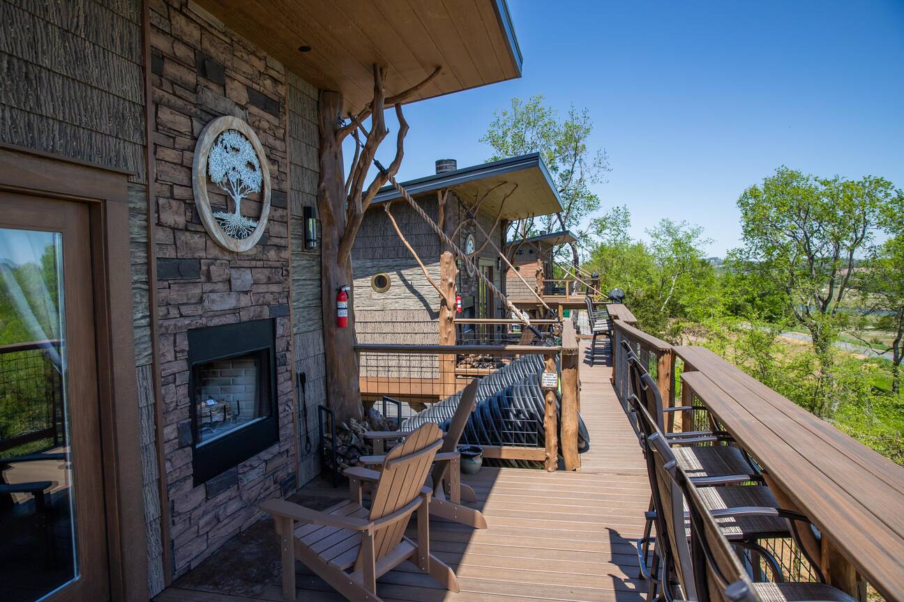 Jane top level porch with seating for 2 at wood burning fireplace. Weber gas grill and access to the dueling slides and working drawbridge. 