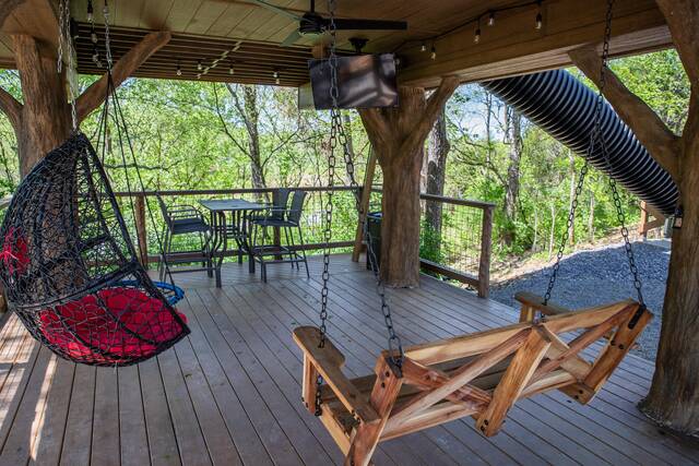 Lower level porch features swings, rope climbs, table top seating for 4, 50" flat screen TV, secret ladder with access to the escape hatch. 