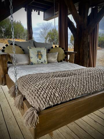 Lower porch custom made outdoor swinging day bed. 