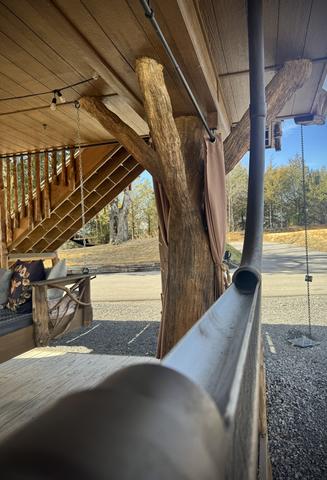 DRINK CHUTE EXIT ON LOWER DECK OF HONEY HOLE LUXE TREEHOUSE AT SANCTUARY TREEHOUSE RESORT