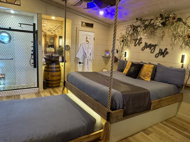 SECRET ROLL OUT QUEEN BED - TURN THE WHEEL ON THE WALL TO REVEAL AND INTERACTIVE FEATURE - LUXURY BEDDING PROVIDED