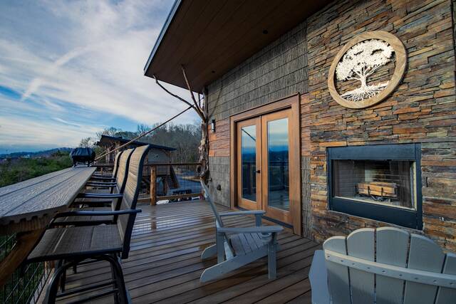 Top level porch features a wood burning fireplace, seating for 2 by the fire and a sit up bar top with seating for 4. 