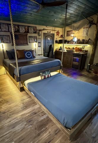 2 SECRET ROLL OUT QUEEN BEDS - TURN THE WHEEL ON THE WALL TO REVEAL AN INTERACTIVE FEATURE AT SANCTUARY TREEHOUSE RESORT IN THE SMOKY MOUNTAINS