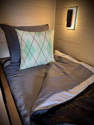 LOWER BUNK - READING LIGHT - USB CHARGE PORT - PORT HOLE WINDOW - LUXURY BEDDING AND SLEEPING BAGS PROVIDED