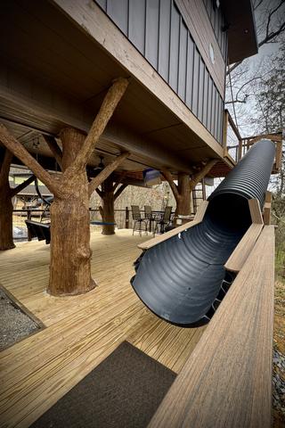 LOWER DECK - 20-FOOT SLIDE AT DON'T STOP BE-LEAFING TREEHOUSE - SANCTUARY TREEHOUSE RESORT