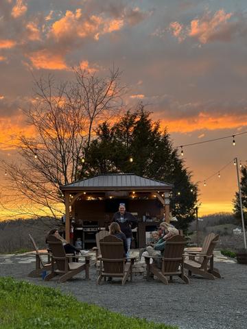 COMMUNITY OUTDOOR KITCHEN AND FIRE PIT GATHERING AREA AT SANCTUARY TREEHOUSE RESORT