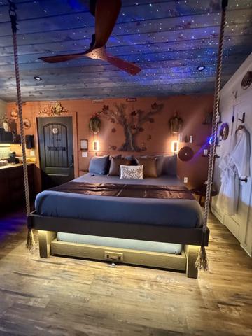 ROPE SUSPENDED KING BED WITH SECRET ROLL OUT QUEEN - SPEAK EASY FRONT DOOR - LUXURY BEDDING PROVIDED