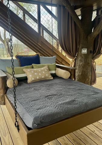 OUTDOOR SWINGING DAY BED - LOWER DECK AT THE FOUR TREE-SONS LUXURY TREEHOUSE IN THE SMOKY MOUNTAINS