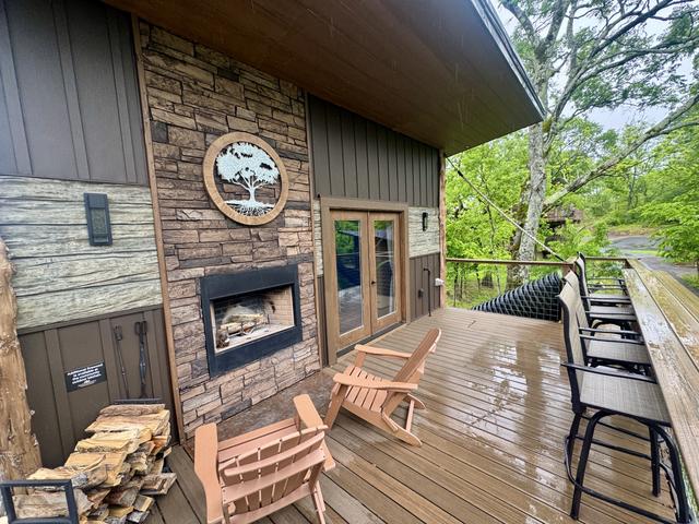 UPPER DECK - OUTDOOR WOOD BURNING FIREPLACE - ADIRONDACK CHAIRS - BAR TOP SEATING FOR 4 - UNLIMITED FIREWOOD AND FIRE STARTER KIT - 20-FOOT SLIDE ACCESS - ESCAPE HATCH