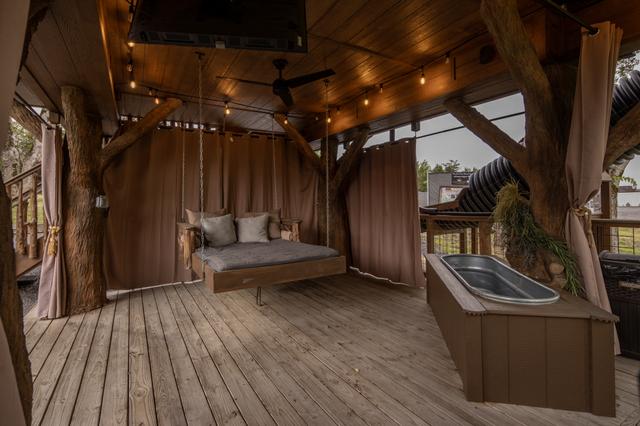 TAKE A NAP ON THE OUTDOOR SUSPENDED DAY BED - PRIVACY CURTAINS - SOAKING TUB - 50" TV - BAR TOP SEATING FOR 2 - BISTRO LIGHTING - DRINK CHUTE