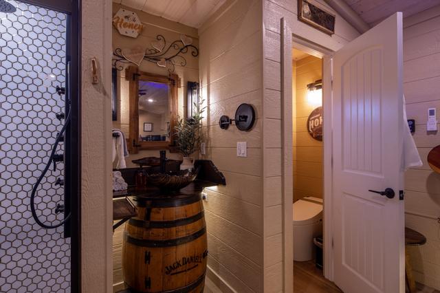 CUSTOM JACK DANIELS VANITY - MAKE UP MIRROR - TILE SHOWER - COMPLIMENTARY ROBES - TOILET CLOSET - PRIVACY CURTAIN - HAIR DRYER - LINENS, TOWEL WARMER, AND TOILETRIES ARE PROVIDED