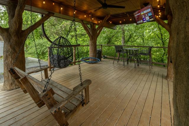 LOWER DECK - SWINGS  - ROPE CLIMB - TABLE TOP SEATING FOR 4 - DRINK CHUTE - 50" TV - ESCAPE HATCH - SECRET LADDER - 20 FOOT SLIDE - BISTRO LIGHTING - OUTDOOR FAN