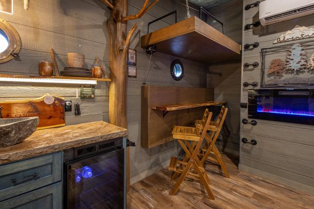 CRANK UP THE LOWER BUNK TO REVEAL A TABLE TOP AND BAR TOP SEATS FOR TWO - EXTRA DINING OR WORK SPACE