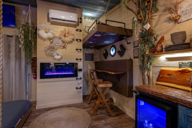 CRANK THE LOWER BUNK UP TO REVEAL A TABLE TOP AND BAR STOOL SEATS FOR TWO FOR EXTRA DINING OR WORK SPACE