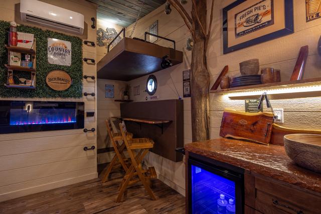 CRANK UP THE LOWER BUNK TO REVEAL A TABLE TOP AND TWO BAR STOOLS FOR INDOOR DINING OR WORK SPACE