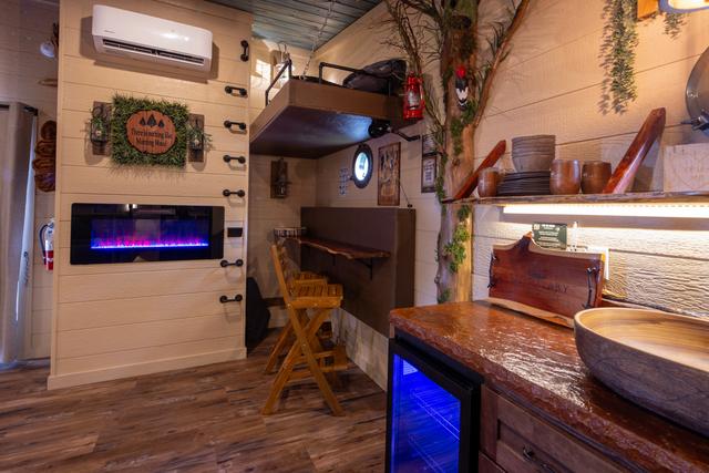 CRANK THE HANDLE AND REVEAL A BAR TOP FOR TWO WITH TWO BAR STOOLS FOR EXTRA DINING OR WORK SPACE