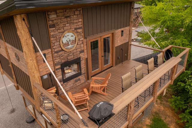 UPPER DECK FROM ABOVE - STONE WOOD-BURNING FIREPLACE, GAS GRILL, AND THE 20-FOOT SLIDE ENTRANCE