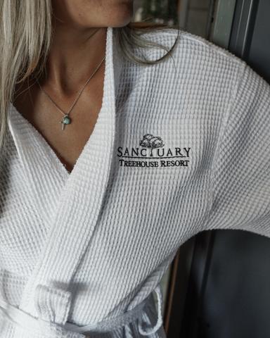 Woman in Sanctuary Treehouse Resort robe.