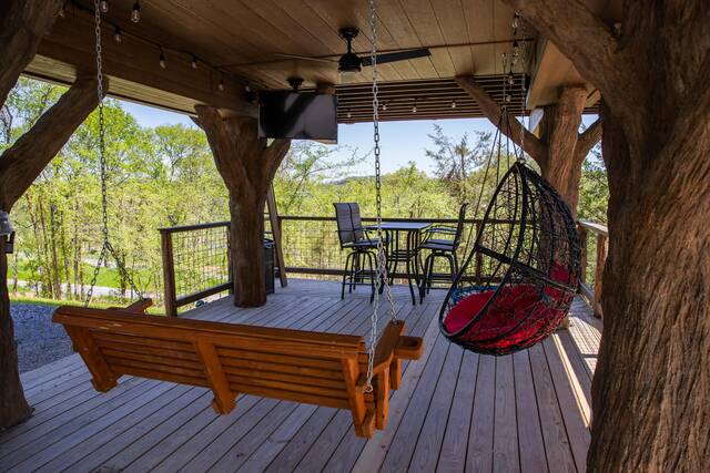 Lower level porch features a 50" flat screen, swings, rope climbs, secret ladder with escape hatch and table top seating for 4. 