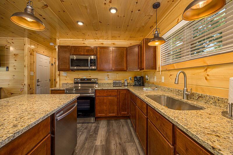 Enjoy snacks to holiday meals in your cabin's fully equipped kitchen. at Big Splash Lodge in Gatlinburg TN
