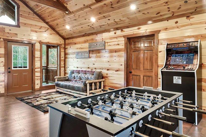 Enjoy endless arcade & foosball challenges during your cabin stay in the Smoky Mounains.  at Cabin Fever Vacation in Gatlinburg TN