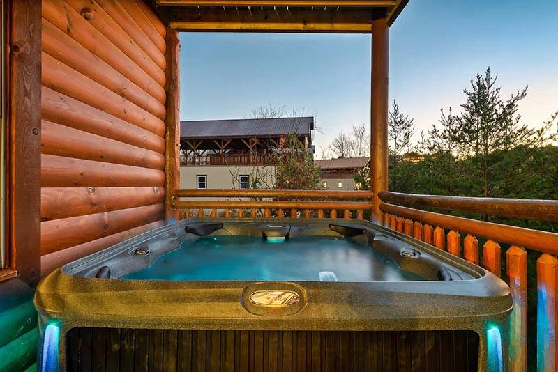Relax in the warm bubbling waters with the Smokies sunset. at Cabin Fever Vacation in Gatlinburg TN