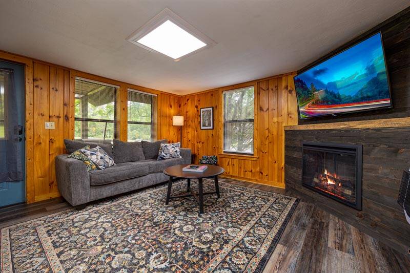 Gas log fireplace in your cabin's living room. at Pigeon Forge Getaway in Gatlinburg TN