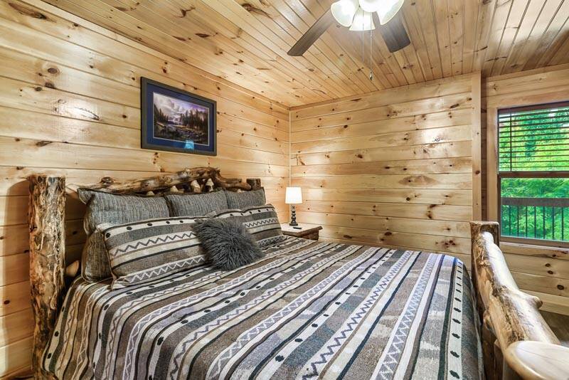 Comfort comes easy in this king sized log bed. at Enchanted Spirit in Gatlinburg TN