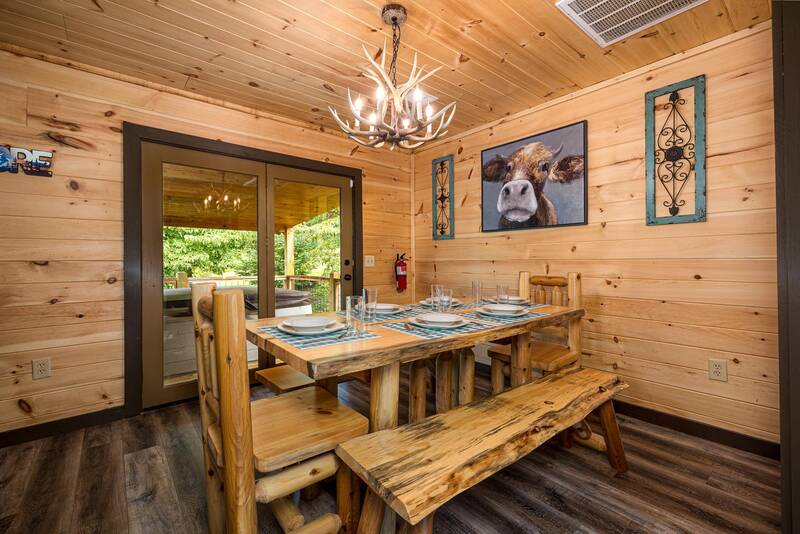 Cabin dining room with log table and bench. at Mountain Creek View in Gatlinburg TN