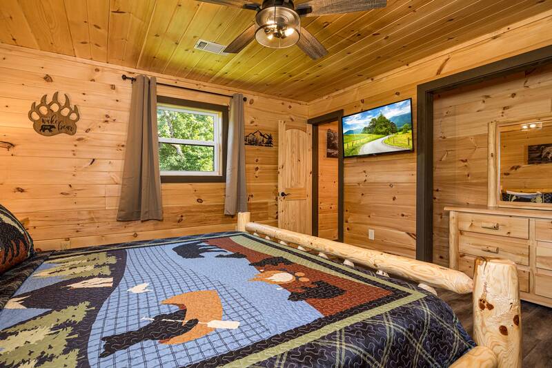 Comfy log bed and tv in your cabin's third bedroom. at Mountain Creek View in Gatlinburg TN