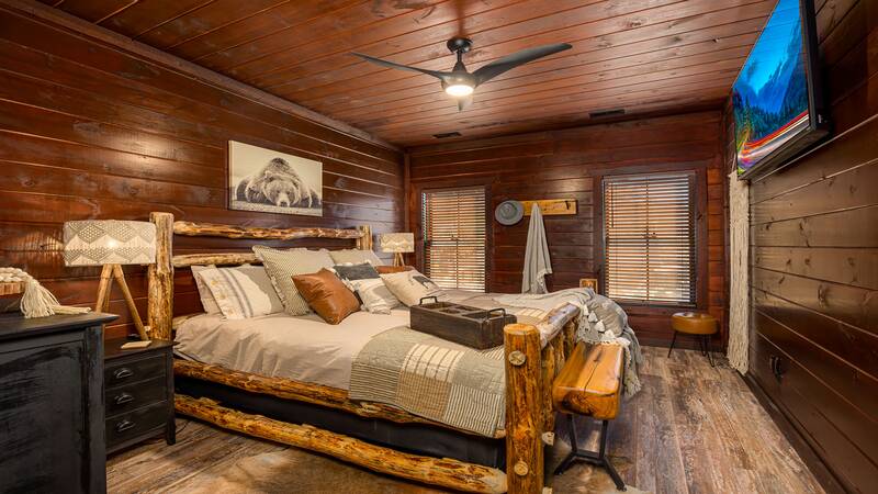 Enjoy the comfort of your king sized log bed. at Stonehenge Cabin in Gatlinburg TN