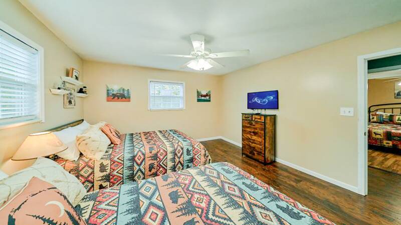 Third bedroom with two full beds and television. at Bear Splashin Fun in Gatlinburg TN