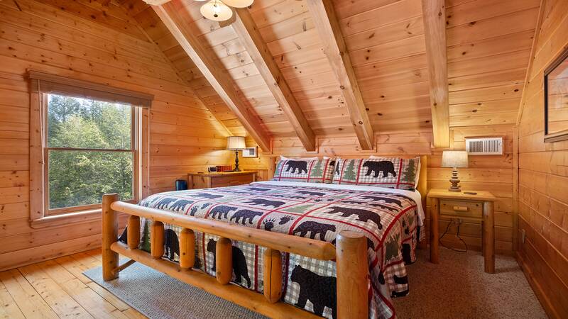 Fourth upstairs bedroom with king sized log bed. at Moonlight Pines Lodge in Gatlinburg TN