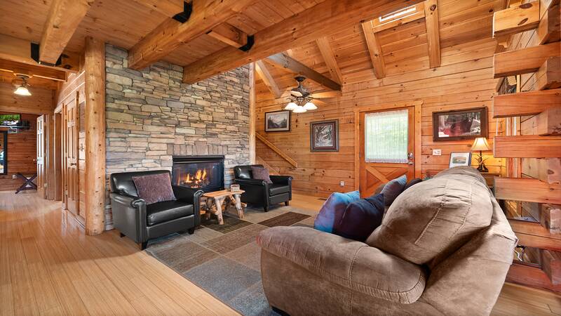 Seasonal warmth comes from the cabin's stacked stone fireplace. at Moonlight Pines Lodge in Gatlinburg TN