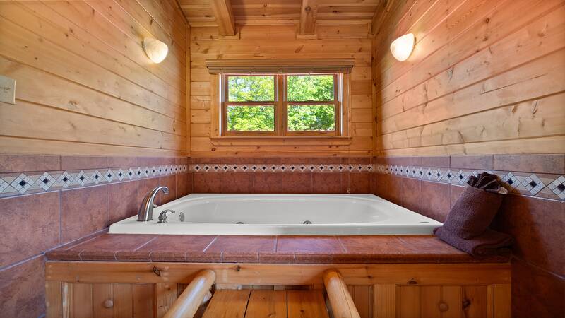 Jacuzzi tub in your Smoky Mountains cabin's fourth bedroom. at Moonlight Pines Lodge in Gatlinburg TN
