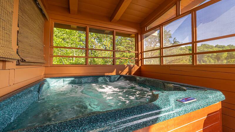Screen enclosed Smoky Mountains cabin hot tub. at Moonlight Pines Lodge in Gatlinburg TN